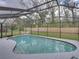 Screened pool features an in-ground pool, tile deck, and fenced yard at 2745 Horseshoe Dr, Plant City, FL 33566