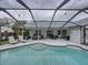 The screened in-ground pool is surrounded by outdoor seating and dining at 2745 Horseshoe Dr, Plant City, FL 33566