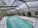 Screened in-ground pool with patio seating, dining, and outdoor kitchen at 2745 Horseshoe Dr, Plant City, FL 33566