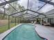 Screened in-ground pool area offers comfortable patio seating and deck loungers at 2745 Horseshoe Dr, Plant City, FL 33566