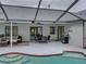 Enclosed pool area with ample seating and a screen enclosure that overlooks the backyard at 2745 Horseshoe Dr, Plant City, FL 33566
