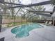 Screened-in pool area with a fenced yard, lounge chairs, and outdoor seating at 2745 Horseshoe Dr, Plant City, FL 33566