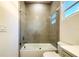 Bathroom featuring a bathtub with glass doors, toilet, and vanity with white cabinets at 3012 E 149Th Ave, Lutz, FL 33559