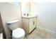 Bathroom featuring a toilet and a modern sink with white cabinets at 3012 E 149Th Ave, Lutz, FL 33559