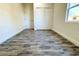 An empty bedroom features laminate flooring, closet and a window that lets in natural light at 3012 E 149Th Ave, Lutz, FL 33559