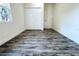 An empty bedroom features laminate flooring, closet and a window that lets in natural light at 3012 E 149Th Ave, Lutz, FL 33559