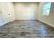 An empty bedroom features laminate flooring, closet and a window that lets in natural light at 3012 E 149Th Ave, Lutz, FL 33559