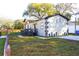 Beautifully landscaped exterior with gray trim, new paved driveway, and green lawn at 3012 E 149Th Ave, Lutz, FL 33559