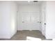 The hallway features laminate flooring and multiple doors with black hardware at 3012 E 149Th Ave, Lutz, FL 33559