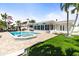 Backyard pool, spa, lawn, and patio at 3102 W Vina Del Mar Blvd, St Pete Beach, FL 33706