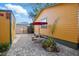 Backyard patio area with stone table, benches, and red umbrella, perfect for outdoor dining at 3235 8Th N Ave, St Petersburg, FL 33713