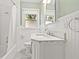 Bright bathroom featuring classic white subway tile, beadboard, and a marble-topped vanity at 3235 8Th N Ave, St Petersburg, FL 33713