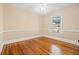 Bedroom with hardwood floors, light-colored walls, and a bright window overlooking greenery at 3235 8Th N Ave, St Petersburg, FL 33713