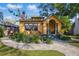 Delightful yellow home with a brick walkway, verdant landscaping, and covered front porch at 3235 8Th N Ave, St Petersburg, FL 33713