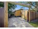 Rear of yellow home, partial fencing, gate and gravel area at 3235 8Th N Ave, St Petersburg, FL 33713