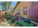 Side view of a yellow home with red trim, brick chimney and lush landscaping at 3235 8Th N Ave, St Petersburg, FL 33713