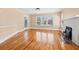 Spacious living room featuring gleaming hardwood floors and a charming brick fireplace at 3235 8Th N Ave, St Petersburg, FL 33713
