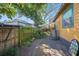Outdoor space features stone path between a wood fence and the yellow-painted house at 3235 8Th N Ave, St Petersburg, FL 33713