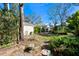 Backyard area featuring a stone patio, garden and lush landscaping at 3810 W Granada St, Tampa, FL 33629