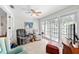 Bright sunroom features neutral tile floors, ceiling fan, and windows overlooking the landscaped yard at 3810 W Granada St, Tampa, FL 33629