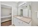 Bathroom featuring a single vanity, tile flooring, and an expansive mirror at 4221 W Spruce St # 1123, Tampa, FL 33607