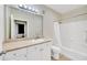 Bathroom featuring a vanity, large mirror, toilet, and tiled shower and tub at 4221 W Spruce St # 1123, Tampa, FL 33607