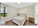Cozy bedroom with large window, wood floors, and comfortable bed at 4221 W Spruce St # 1123, Tampa, FL 33607