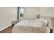 Bedroom featuring wood floors, neutral walls, and a view of mature trees at 4221 W Spruce St # 1123, Tampa, FL 33607