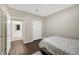 This bedroom boasts hardwood floors, a queen sized bed, and an ensuite bathroom at 4221 W Spruce St # 1123, Tampa, FL 33607