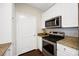 Kitchen area showcasing stainless steel oven, microwave and granite countertop at 4221 W Spruce St # 1123, Tampa, FL 33607