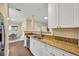 Bright kitchen featuring granite countertops, stainless steel appliances, and white cabinetry at 4221 W Spruce St # 1123, Tampa, FL 33607