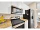 Well-equipped kitchen with stainless steel microwave, oven, and refrigerator at 4221 W Spruce St # 1123, Tampa, FL 33607