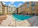 Community pool with lots of lounge chairs surrounded by apartments and palm trees at 4221 W Spruce St # 1123, Tampa, FL 33607