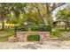 Sign for John R. Lawrence Pioneer Park surrounded by greenery and trees at 439 San Salvador Dr, Dunedin, FL 34698