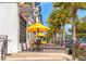 Outdoor seating with yellow umbrellas outside Nature's Food Patch market & cafe at 439 San Salvador Dr, Dunedin, FL 34698