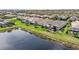 Aerial shot shows the house's position next to a lake, enhancing the scenery at 4857 Tobermory Way, Bradenton, FL 34211