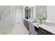 Bright bathroom with marble tile, a glass shower and a vanity area at 4857 Tobermory Way, Bradenton, FL 34211
