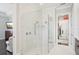 Elegant bathroom with glass shower, marble tile, and views of the closet at 4857 Tobermory Way, Bradenton, FL 34211