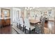 Dining room featuring hardwood floors, coffered ceilings, and a view of the kitchen at 4857 Tobermory Way, Bradenton, FL 34211