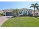 Charming single-story home featuring a well-manicured lawn, lush landscaping, and a two-car garage at 4857 Tobermory Way, Bradenton, FL 34211