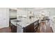 Gourmet kitchen with a large granite island and stainless steel appliances with an open concept to dining at 4857 Tobermory Way, Bradenton, FL 34211