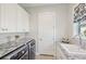 Bright laundry room features granite countertops, washer and dryer, and cabinet space for extra storage at 4857 Tobermory Way, Bradenton, FL 34211