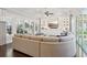 Stylish living room with custom built-ins, a large TV, and access to the outdoor grill at 4857 Tobermory Way, Bradenton, FL 34211