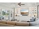 Stylish living room with custom built-ins, a large TV, and access to the outdoor grill at 4857 Tobermory Way, Bradenton, FL 34211