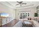 Open-concept living room with dark hardwood floors, recessed lights, modern television and patio view at 4857 Tobermory Way, Bradenton, FL 34211