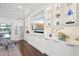 Bright living room with custom cabinets, a large TV, and outdoor views at 4857 Tobermory Way, Bradenton, FL 34211