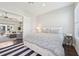 Cozy main bedroom with bed, side table, and doorway to living room has a modern design at 4857 Tobermory Way, Bradenton, FL 34211