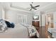 Main bedroom with tray ceiling, hardwood floors, and plantation shutters at 4857 Tobermory Way, Bradenton, FL 34211