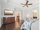 Spacious main bedroom with hardwood floors, a ceiling fan, and a mounted TV at 4857 Tobermory Way, Bradenton, FL 34211