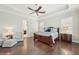 Luxurious main bedroom features hardwood floors, tray ceiling, and elegant furniture at 4857 Tobermory Way, Bradenton, FL 34211